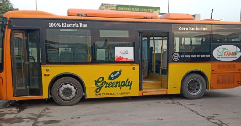 Fully wrapped bus showcasing effective bus advertising across city traffic lanes